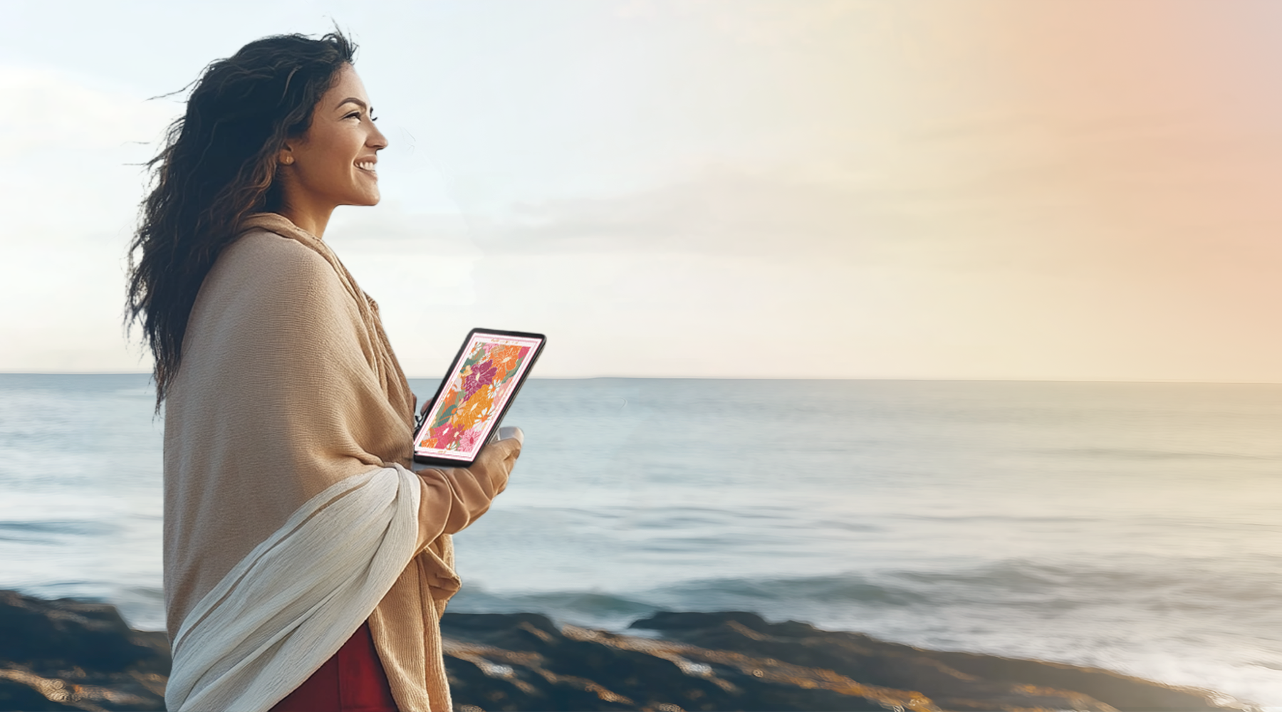 Person using 2025 digital reflection planner near the ocean for daily goal setting and paperless planning